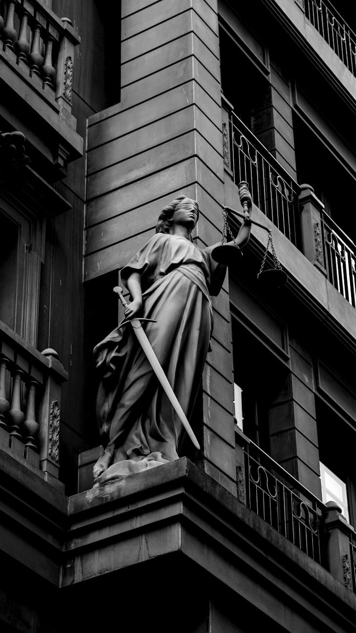 black and white justice statue with sword